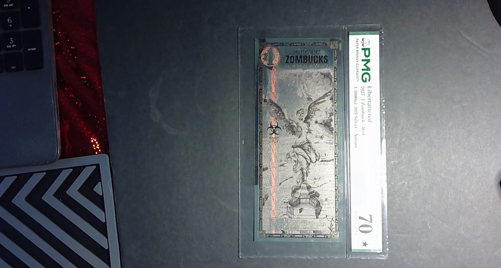 2027 Libertattered 1 Zombuck Red Aurum PMG 70★ – 1/1000 oz .999 Silver