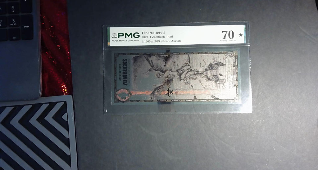 2027 Libertattered 1 Zombuck Red Aurum PMG 70★ – 1/1000 oz .999 Silver
